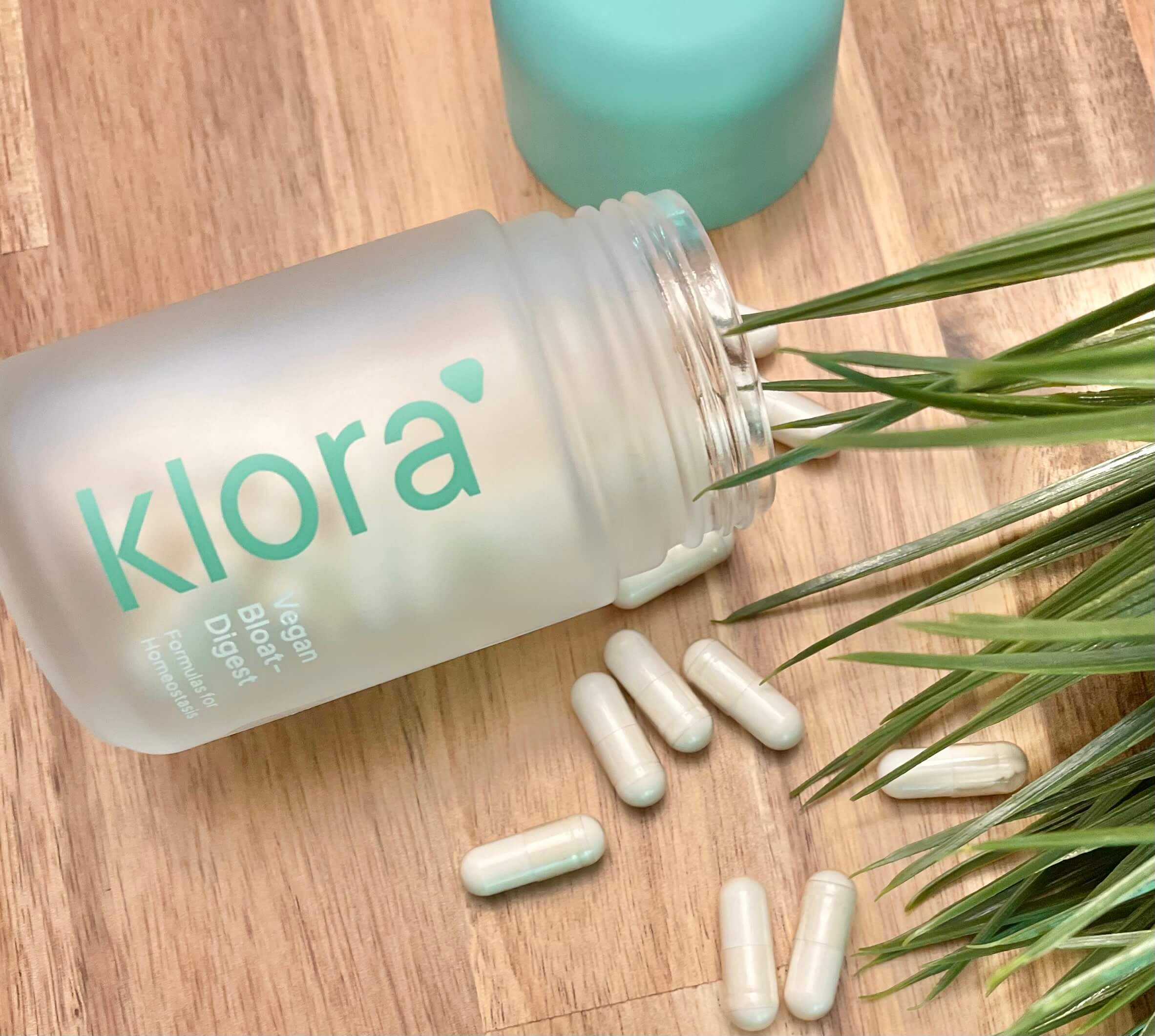 Klora creator holding the supplement at a cafe